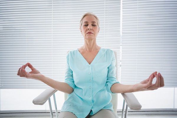 woman meditating in chair